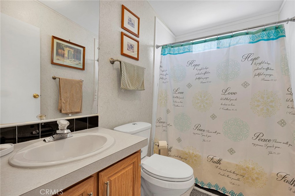 12837 Hacienda Road Phelan, CA 92371 - Photo 20 of 51 a bathroom with a sink toilet and shower
