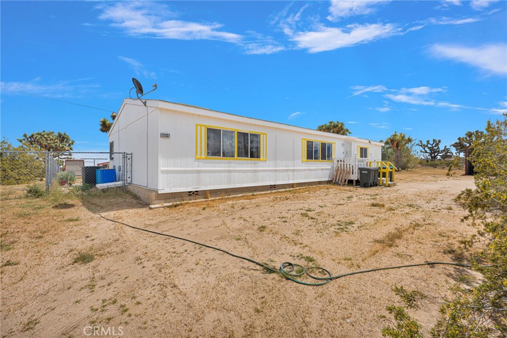 12837 Hacienda Road Phelan, CA 92371 - Photo 2 of 51 a view of a house with a snow in the yard