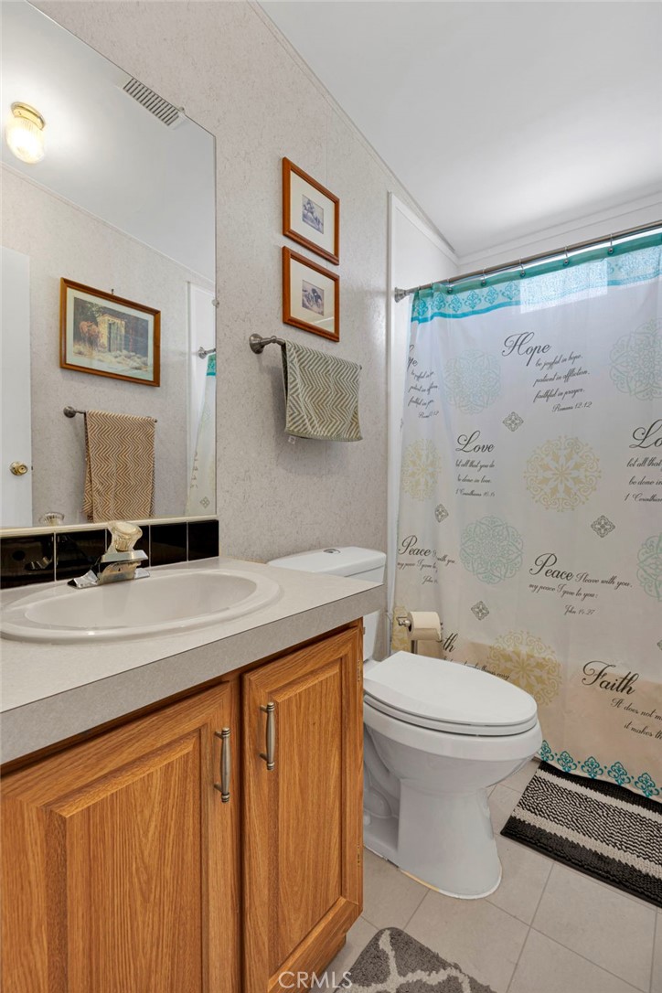 12837 Hacienda Road Phelan, CA 92371 - Photo 21 of 51 a bathroom with a sink toilet and shower