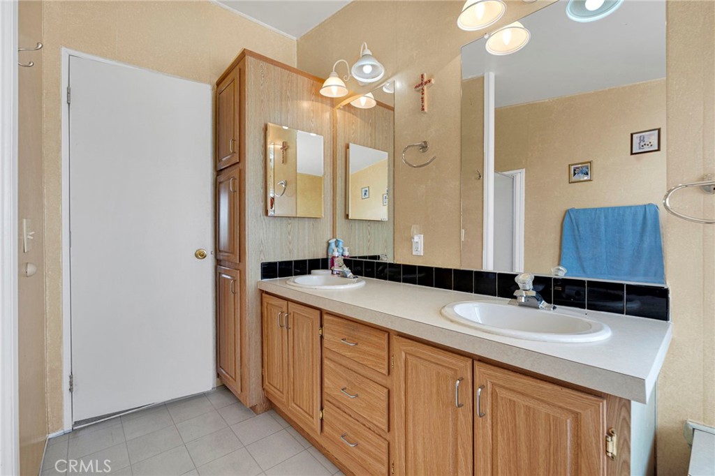 12837 Hacienda Road Phelan, CA 92371 - Photo 27 of 51 a bathroom with a sink and a mirror