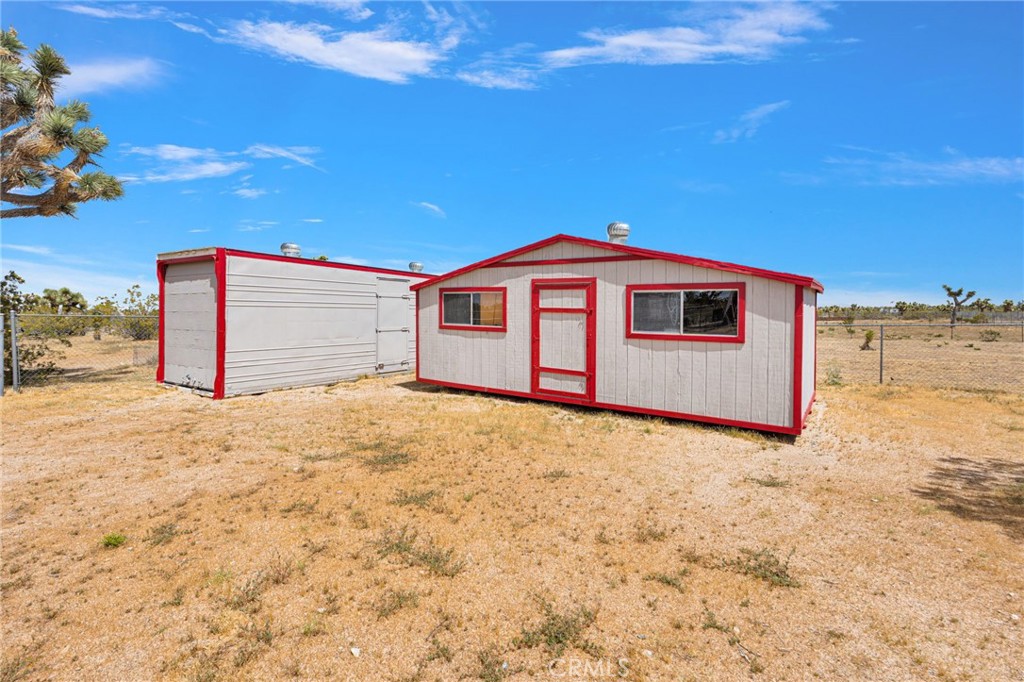 12837 Hacienda Road Phelan, CA 92371 - Photo 29 of 51 a front view of a house with a yard