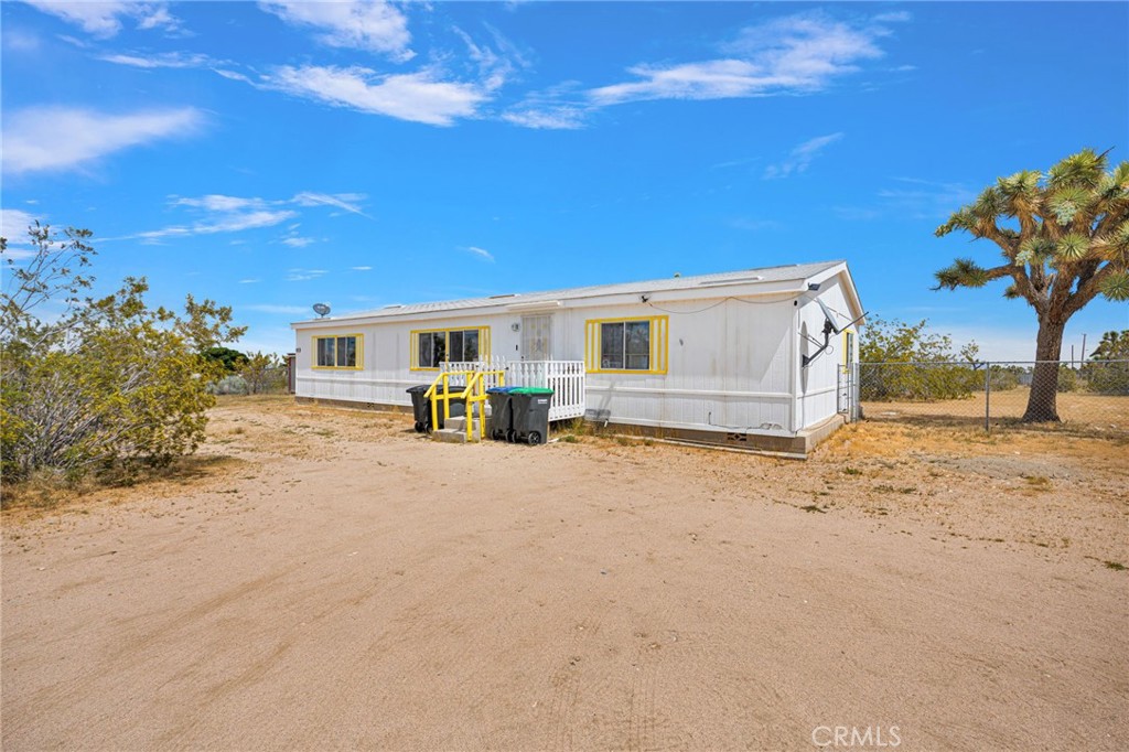 12837 Hacienda Road Phelan, CA 92371 - Photo 3 of 51 a view of house with backyard and tree