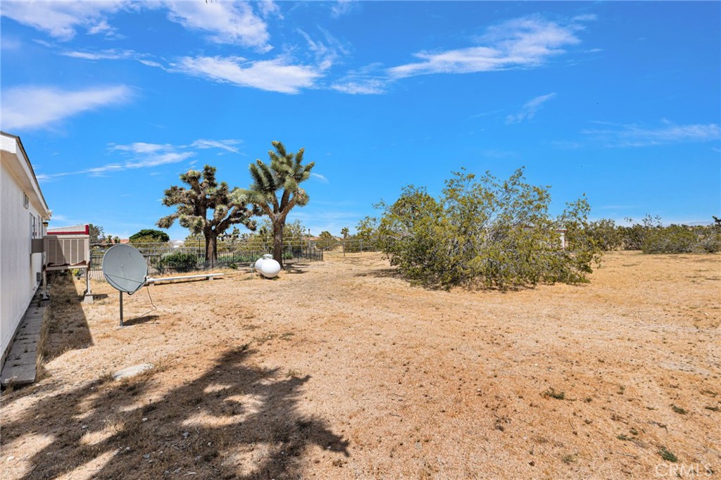 12837 Hacienda Road Phelan, CA 92371 - Photo 38 of 51 a view of a yard with a house