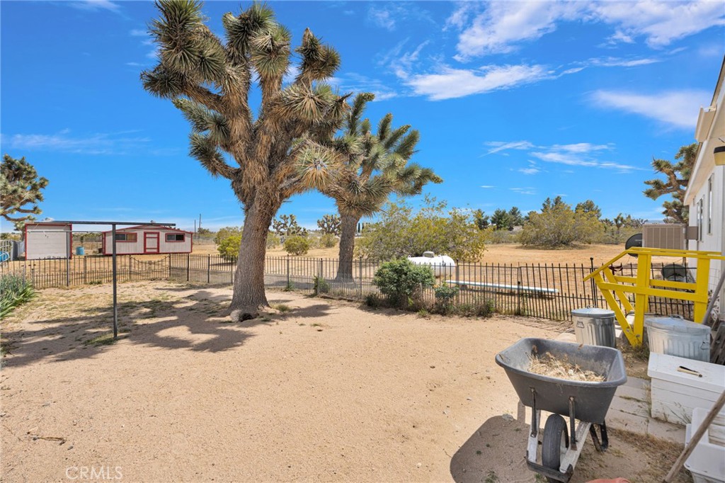 12837 Hacienda Road Phelan, CA 92371 - Photo 39 of 51 a view of a swimming pool with a lounge chairs