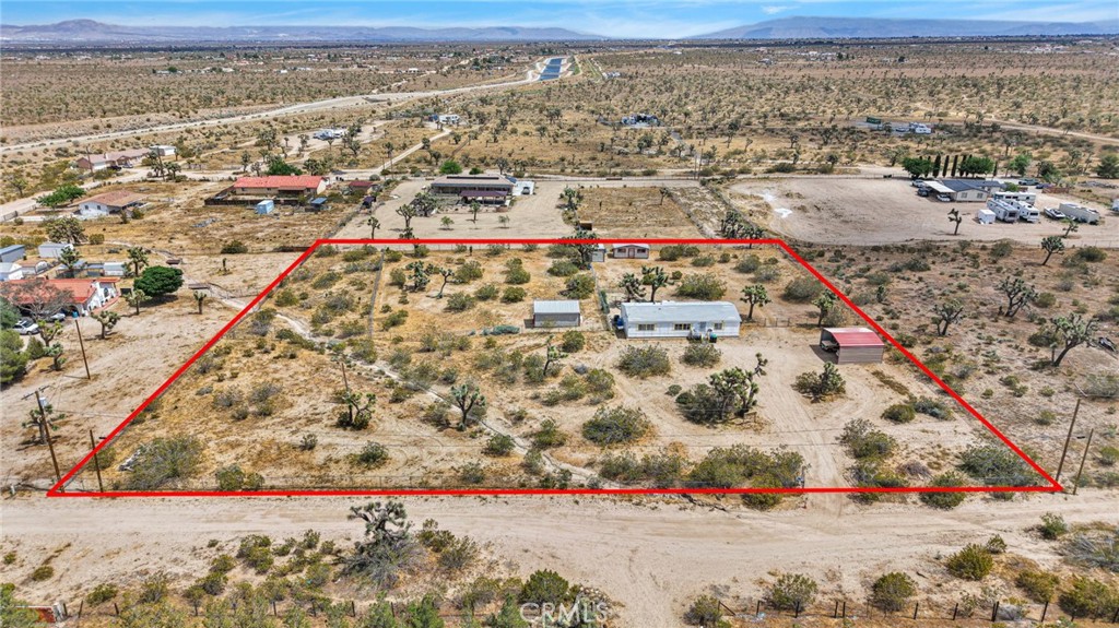 12837 Hacienda Road Phelan, CA 92371 - Photo 47 of 51 an aerial view of residential building and parking space