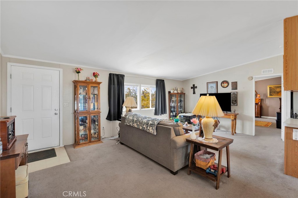 12837 Hacienda Road Phelan, CA 92371 - Photo 6 of 51 a living room with furniture and a flat screen tv