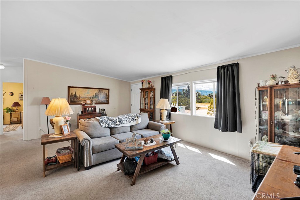 12837 Hacienda Road Phelan, CA 92371 - Photo 7 of 51 a living room with furniture and a window
