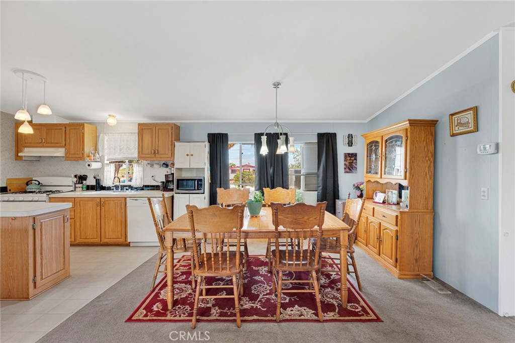 12837 Hacienda Road Phelan, CA 92371 - Photo 10 of 51 a view of a dining room with furniture window and wooden floor