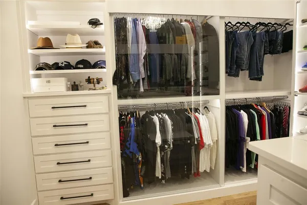 a view of walk in closet with clothes and shoes