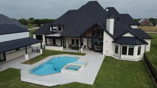 a view of a house with swimming pool and sitting area