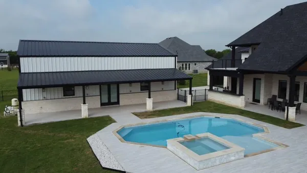 a living room with patio furniture and a fireplace
