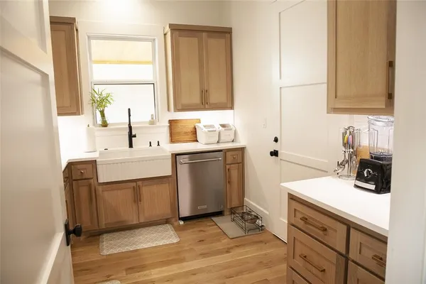 a kitchen with a sink stove and cabinets