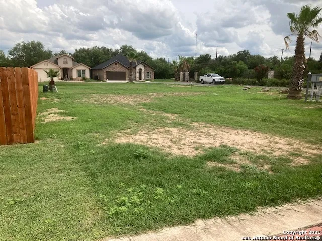 a view of a big yard with a fountain and a big yard