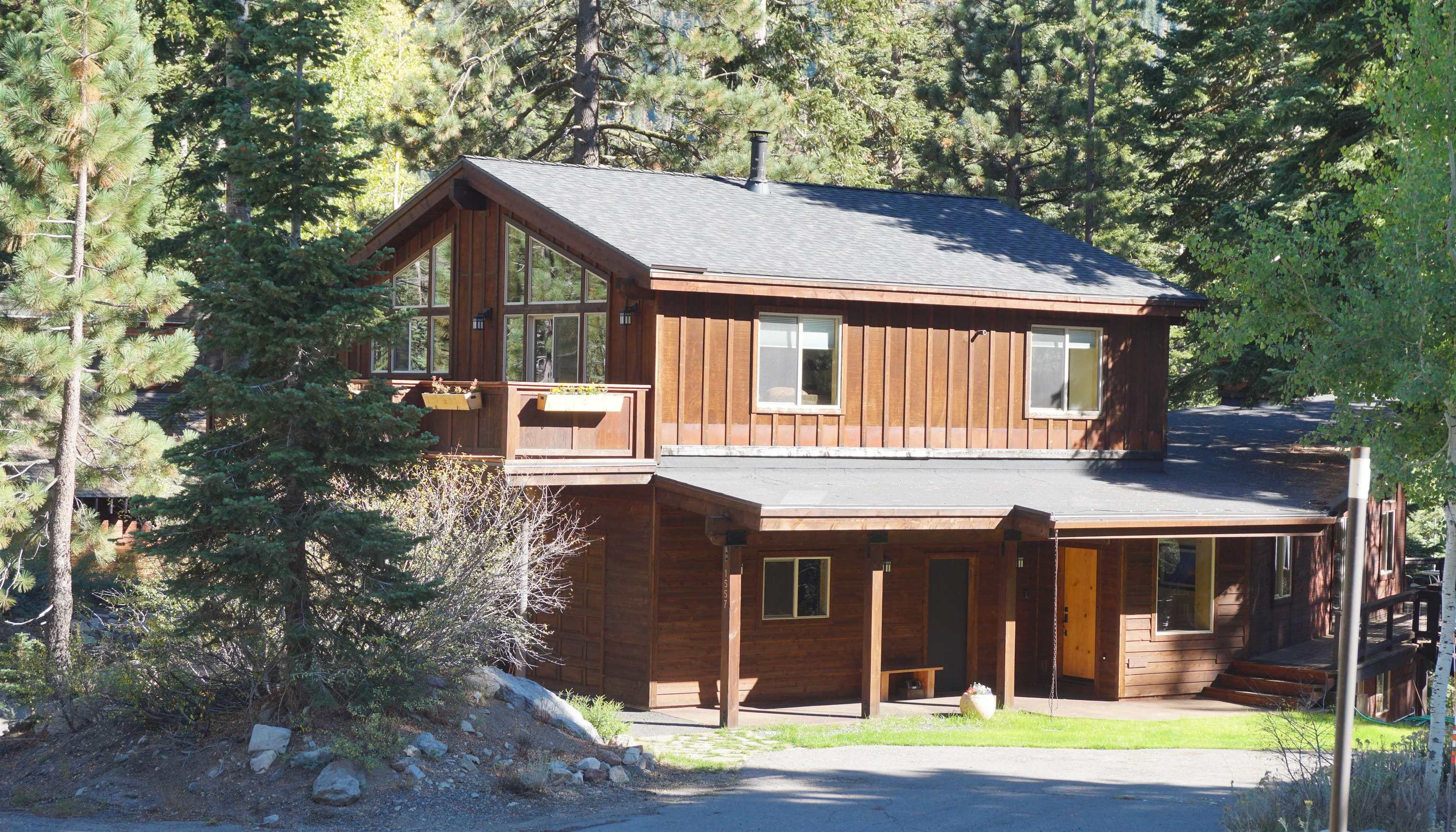 1557 Alpine Meadows Road Alpine Meadows, CA 96146 - Photo 2 of 28 a view of a white house with large windows and a small yard