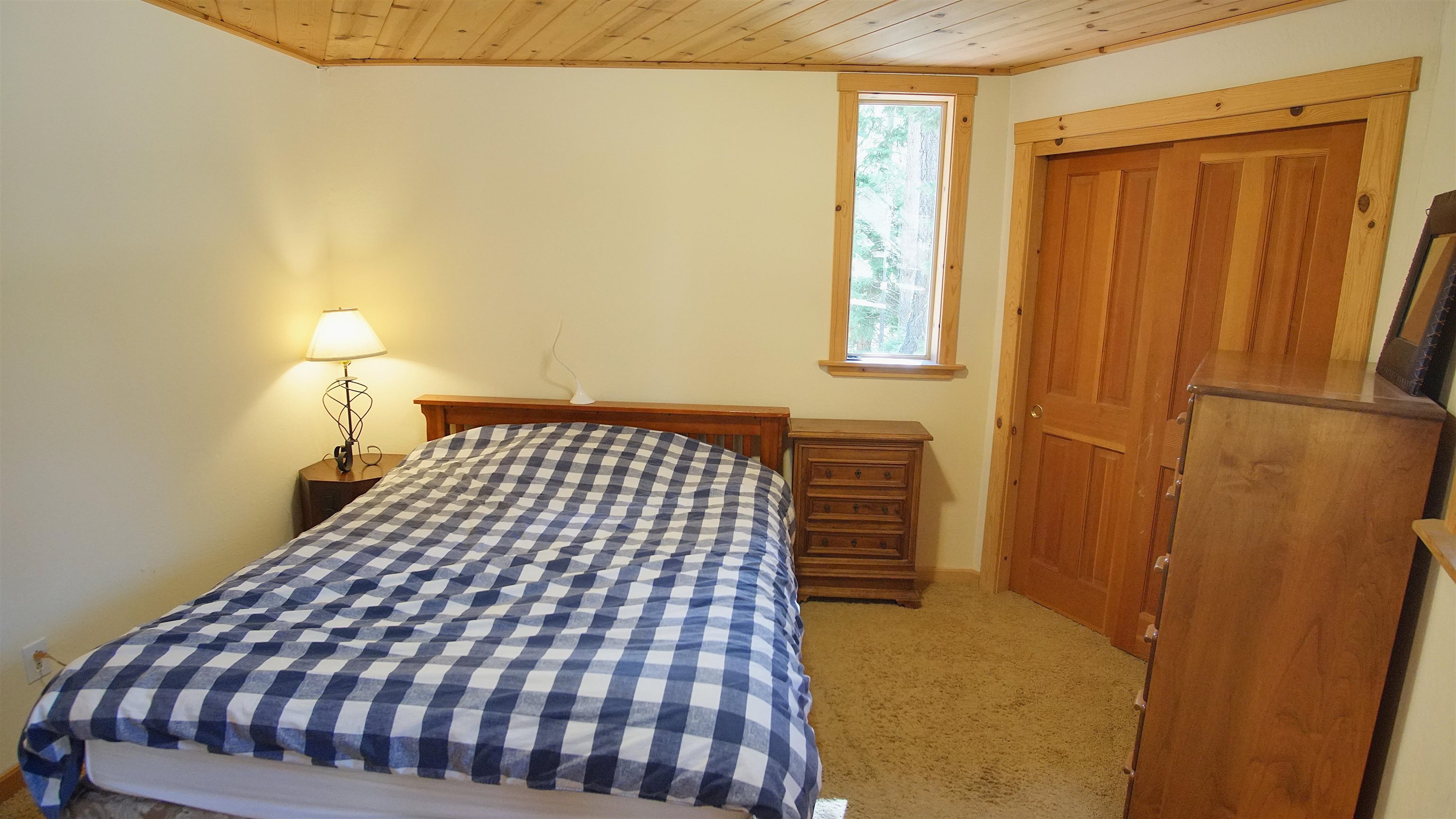 1557 Alpine Meadows Road Alpine Meadows, CA 96146 - Photo 22 of 28 a bedroom with a bed and wooden floor