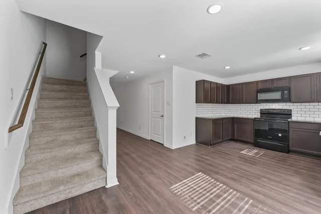 a view of kitchen with sink microwave and refrigerator