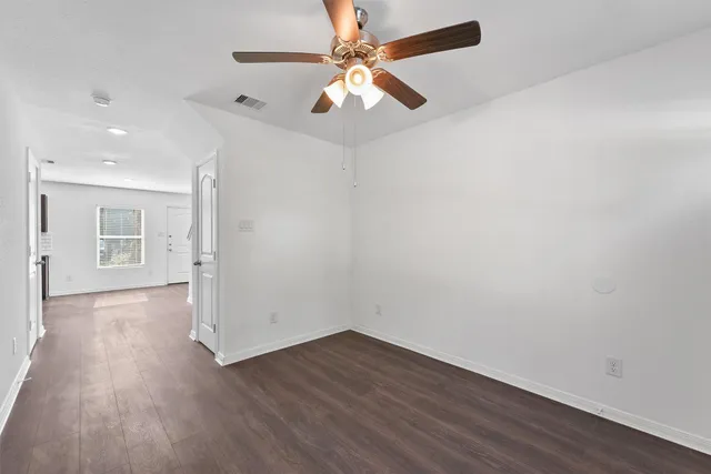 wooden floor in an empty room with a window