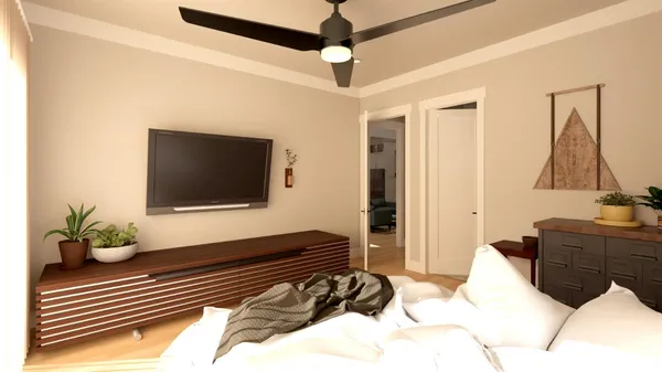 a bedroom with a bed and a flat tv screen on dresser