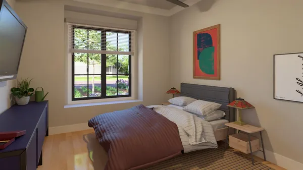 a bedroom with a bed and a window