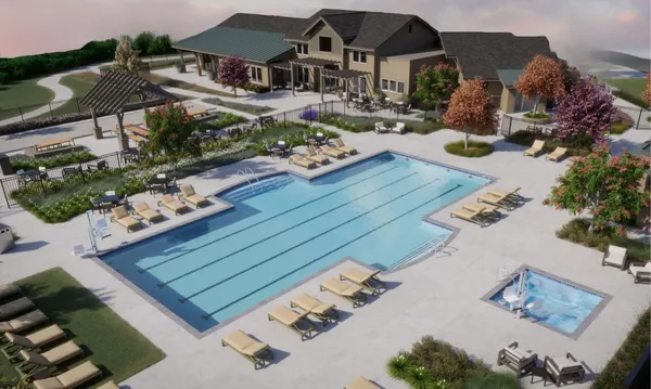 an aerial view of a house with yard swimming pool and outdoor seating