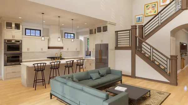 a living room with stainless steel appliances furniture and a kitchen view