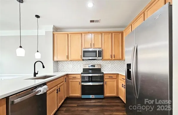 a kitchen with a refrigerator and a sink