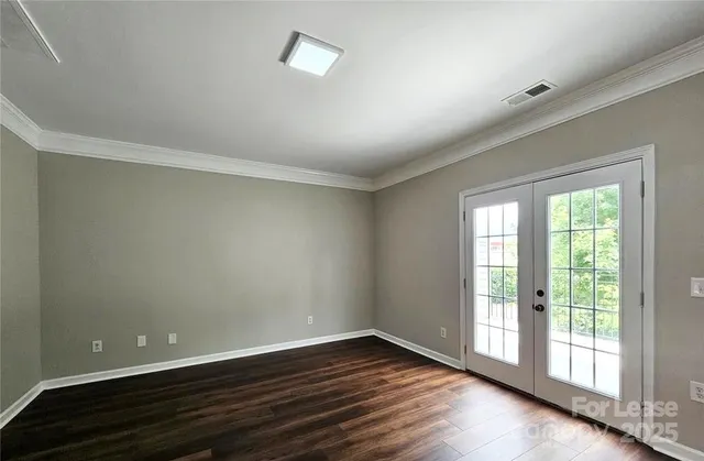 a view of a hallway with wooden floor and a ceiling fan