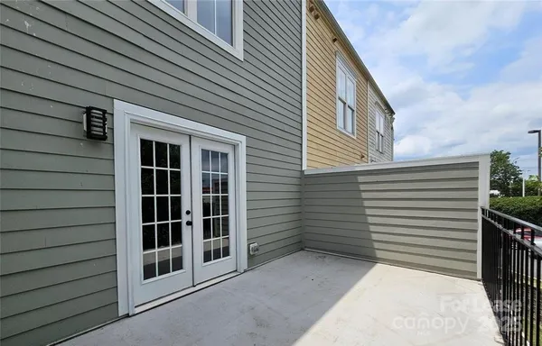 a view of a house with a door and wooden walls