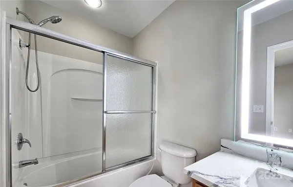 a bathroom with a shower a toilet and a sink
