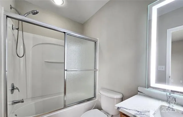 a bathroom with a shower a toilet and a sink