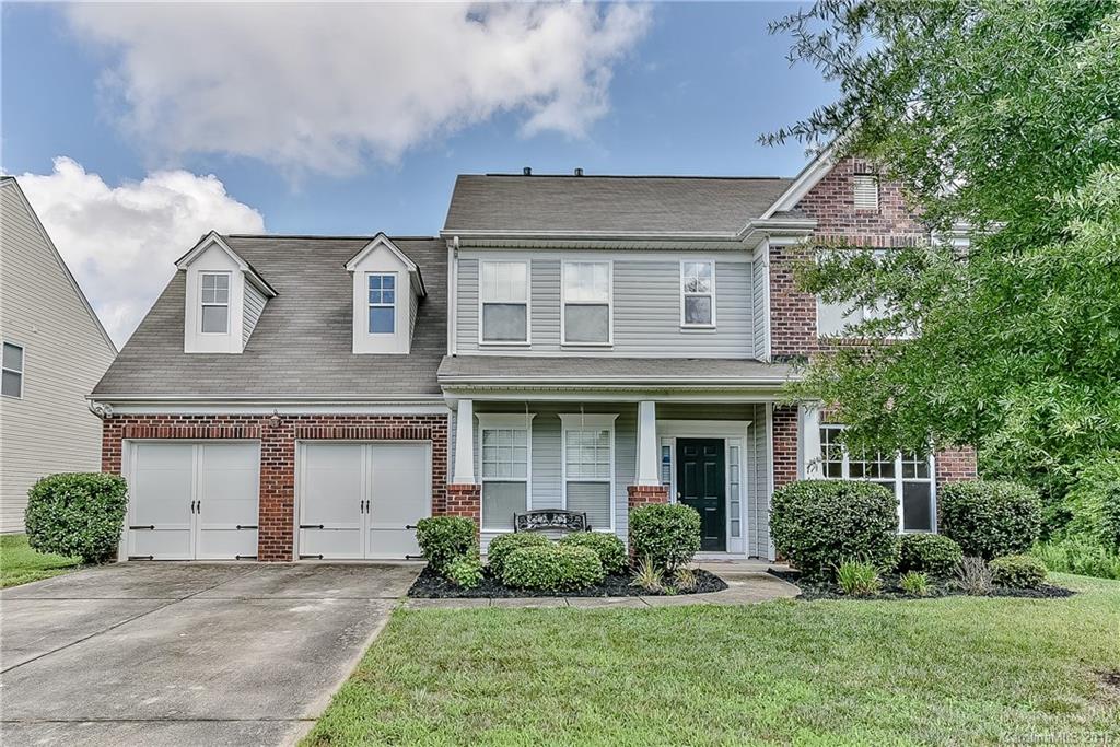 3111 Gloxinia Road Charlotte, NC 28215 - Photo 1 of 24 a front view of a house with a yard and garage