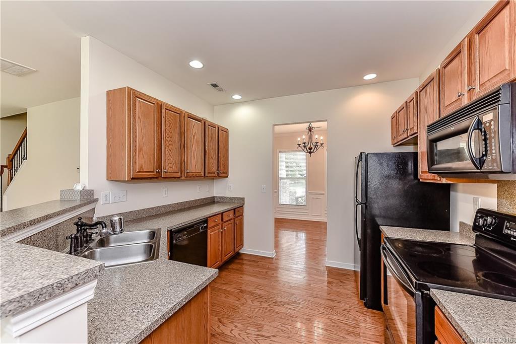 3111 Gloxinia Road Charlotte, NC 28215 - Photo 12 of 24 a kitchen with stainless steel appliances granite countertop a stove a sink and a refrigerator