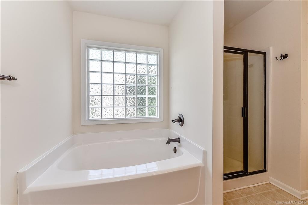 3111 Gloxinia Road Charlotte, NC 28215 - Photo 18 of 24 a white bath tub sitting next to a window