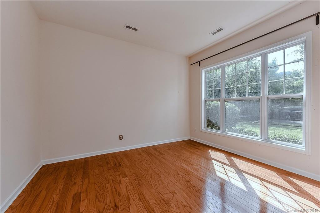 3111 Gloxinia Road Charlotte, NC 28215 - Photo 3 of 24 a view of room with window and wooden floor