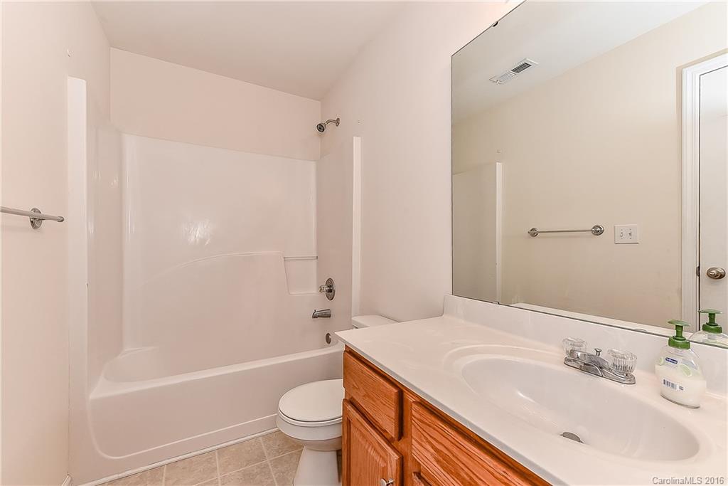 3111 Gloxinia Road Charlotte, NC 28215 - Photo 21 of 24 a bathroom with a sink a toilet and a bathtub