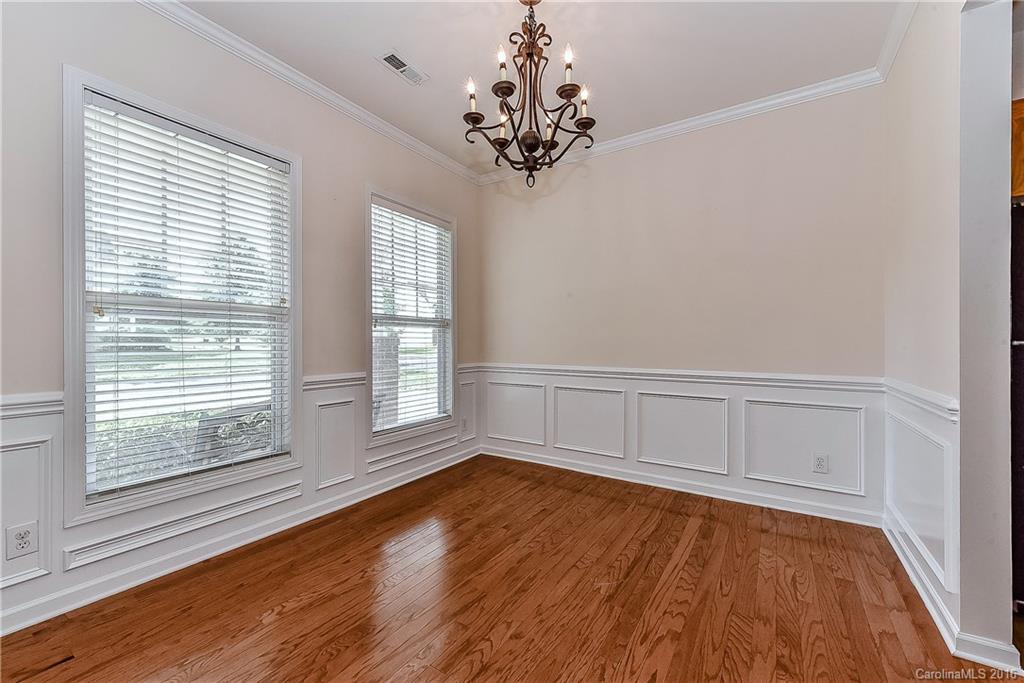 3111 Gloxinia Road Charlotte, NC 28215 - Photo 4 of 24 a view of an empty room with wooden floor and a window