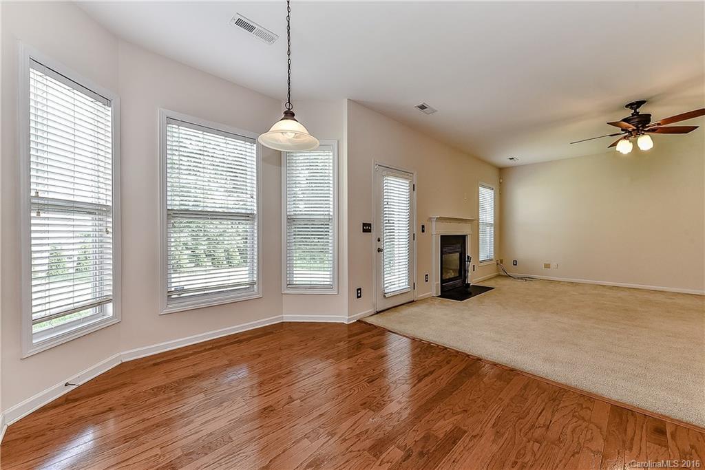 3111 Gloxinia Road Charlotte, NC 28215 - Photo 6 of 24 a view of a livingroom with a ceiling fan window and wooden floor