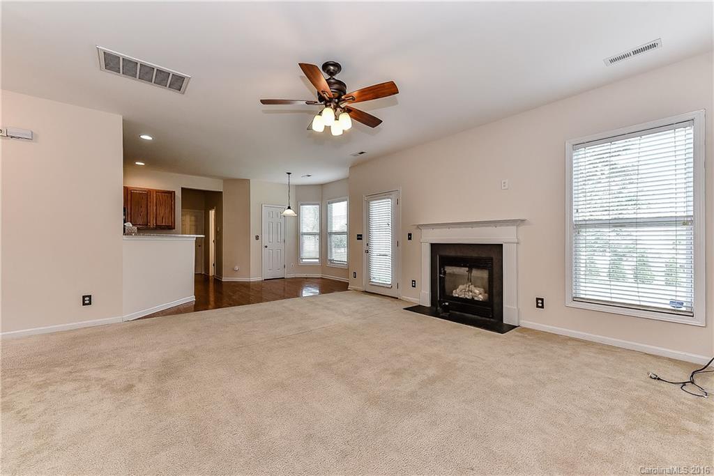 3111 Gloxinia Road Charlotte, NC 28215 - Photo 8 of 24 a view of livingroom with fireplace fan and windows