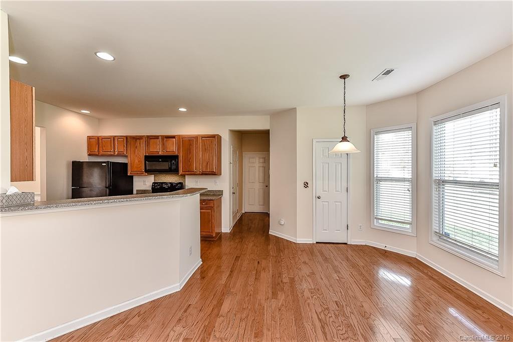 3111 Gloxinia Road Charlotte, NC 28215 - Photo 10 of 24 a view of kitchen with stainless steel appliances refrigerator oven stove and wooden floor