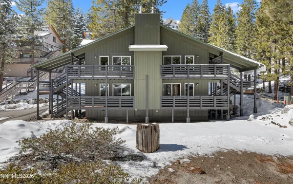 a view of a house with a snow in the yard