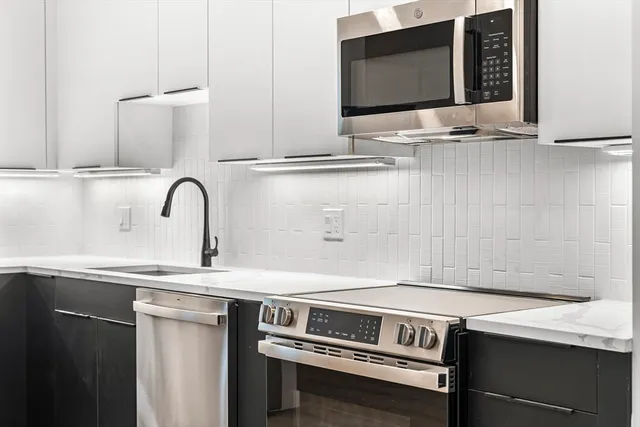 a kitchen with a sink and a microwave