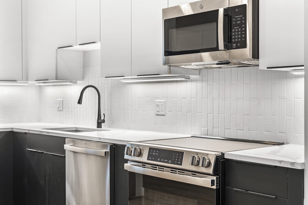 a kitchen with a sink and a microwave