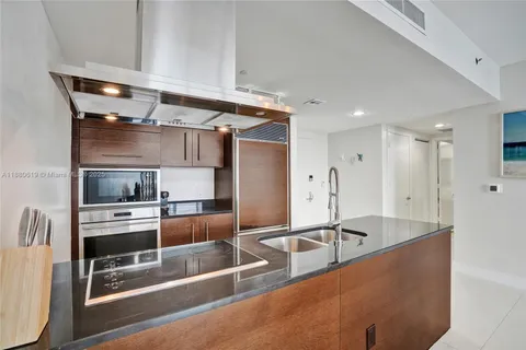 a kitchen with stainless steel appliances a sink a stove and a refrigerator