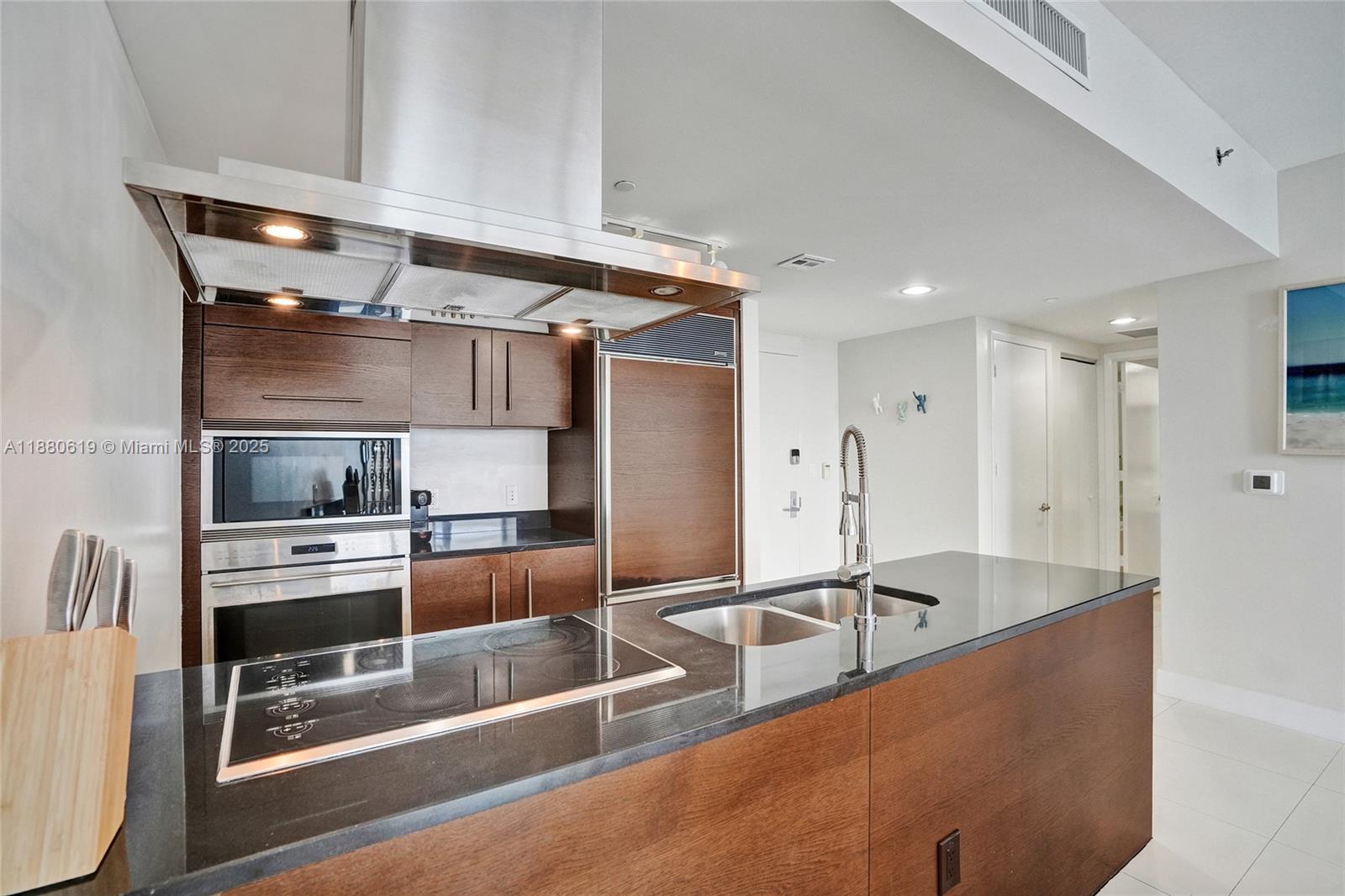 485 Brickell Avenue, Unit 4207 Miami, FL 33131 - Photo 11 of 41 a kitchen with stainless steel appliances a sink a stove and a refrigerator