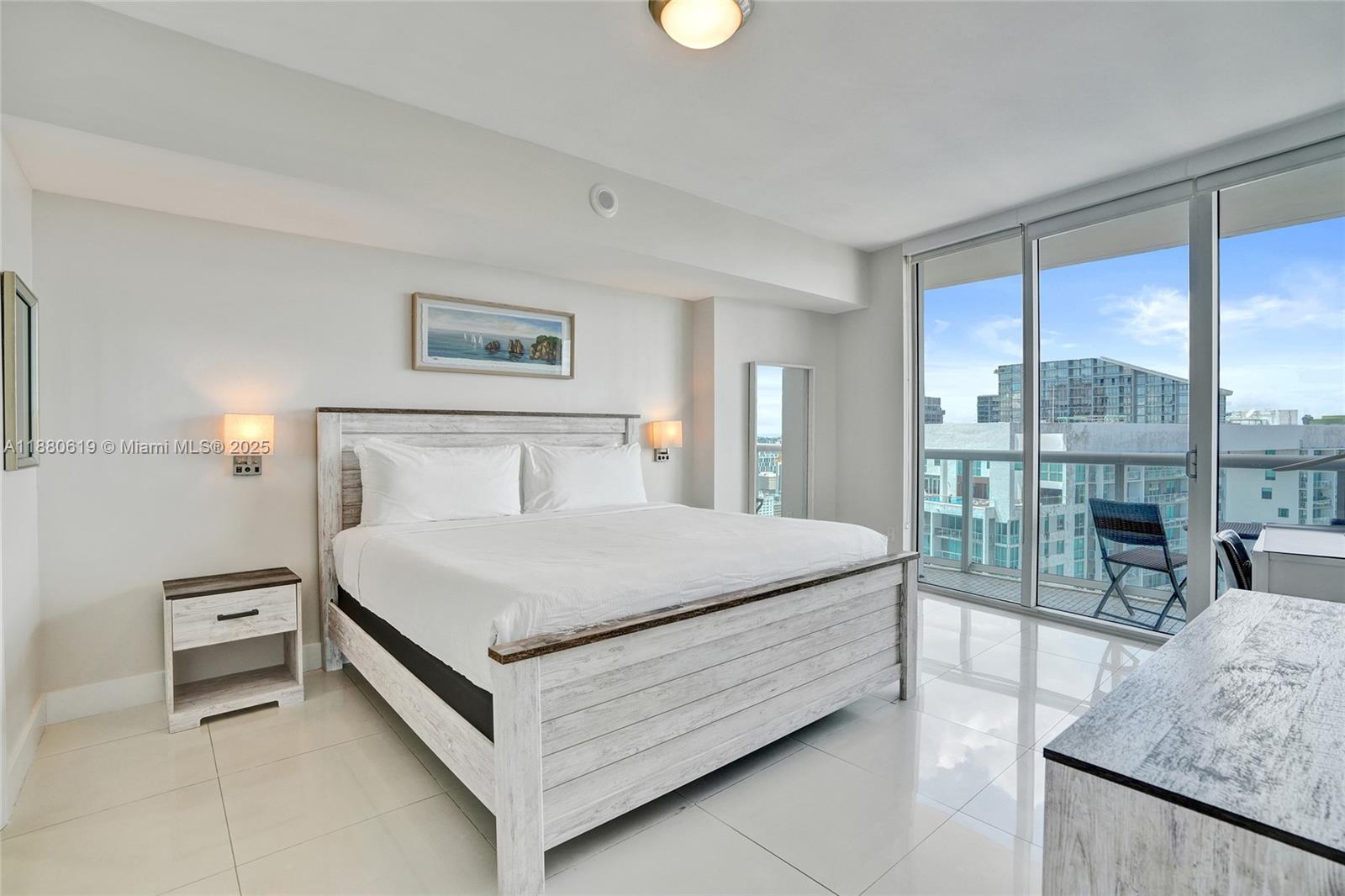 485 Brickell Avenue, Unit 4207 Miami, FL 33131 - Photo 12 of 41 a bedroom with a bed and a large window