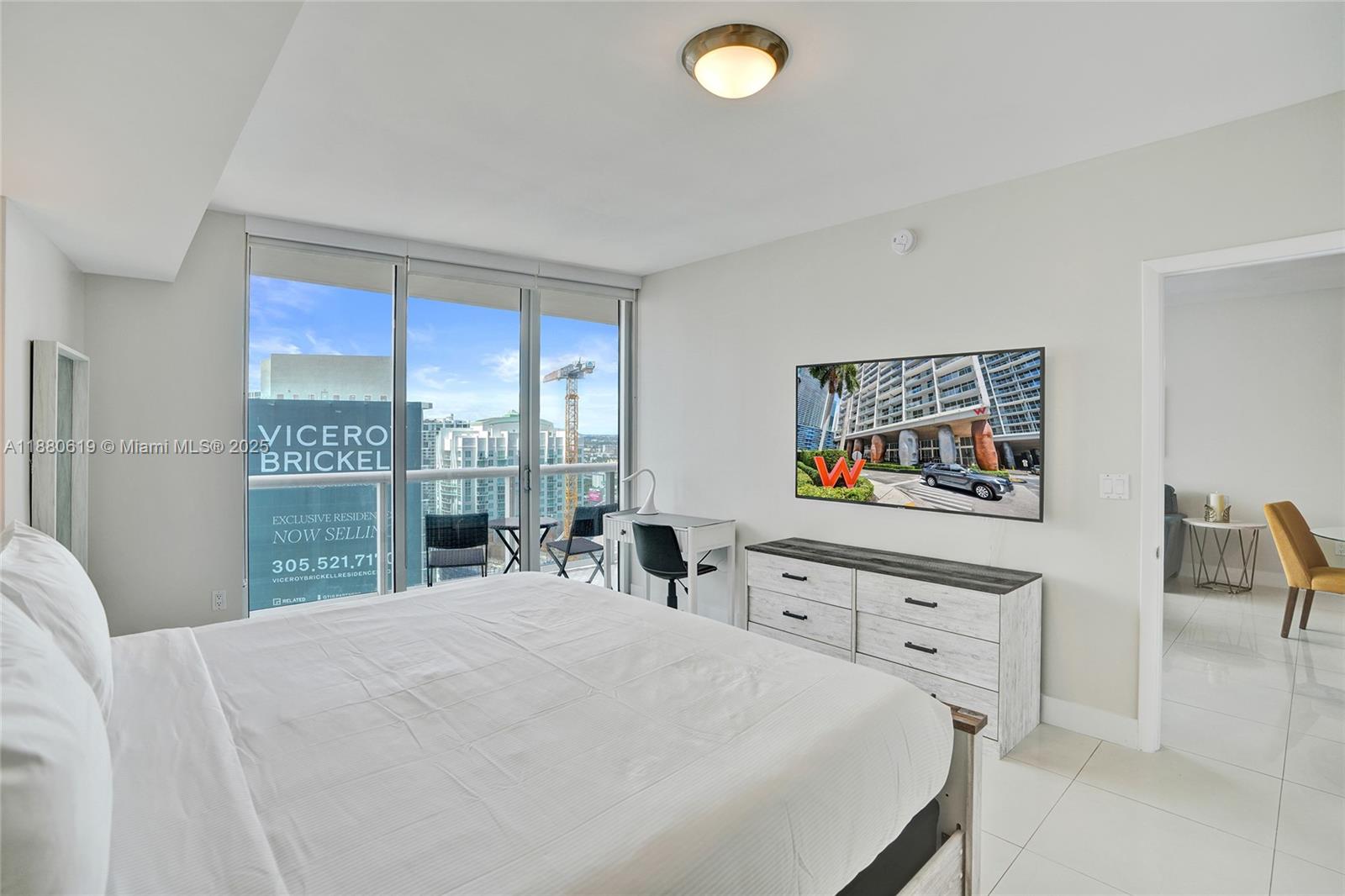 485 Brickell Avenue, Unit 4207 Miami, FL 33131 - Photo 20 of 41 a bedroom with a bed and a large window