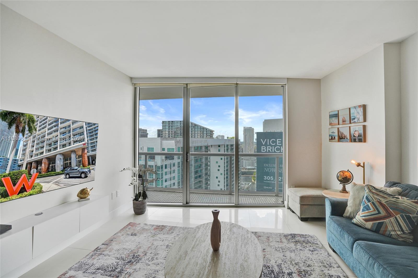 485 Brickell Avenue, Unit 4207 Miami, FL 33131 - Photo 8 of 41 a living room with furniture and a floor to ceiling window