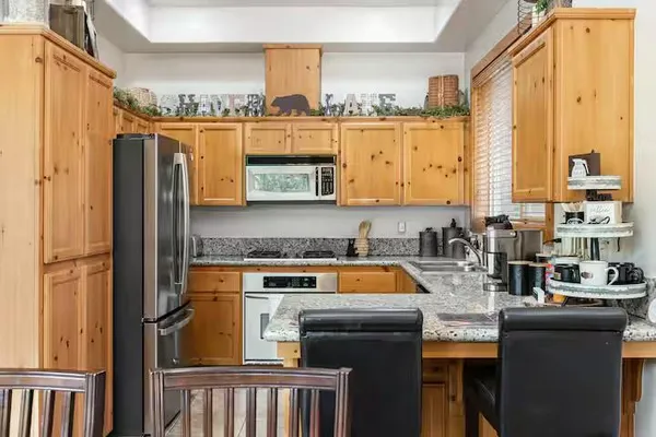 a kitchen with granite countertop a stove and a sink
