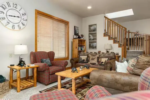 a kitchen with stainless steel appliances granite countertop a refrigerator a stove and a sink with wooden floor