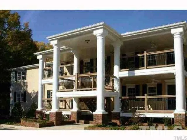 a front view of a building with a garden